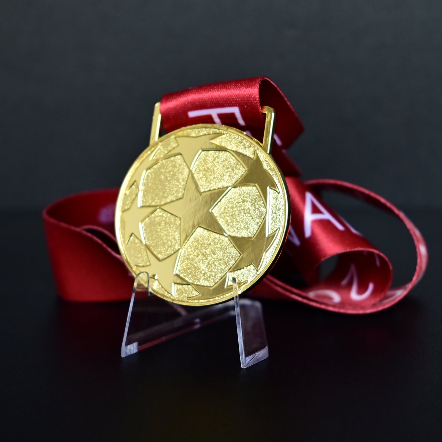 2009 UEFA Champions League Medal Back View, Barcelona Champion Gold Alloy Medal with Starball Pattern, Commemorative Football Medal Close-up on Clear Stand