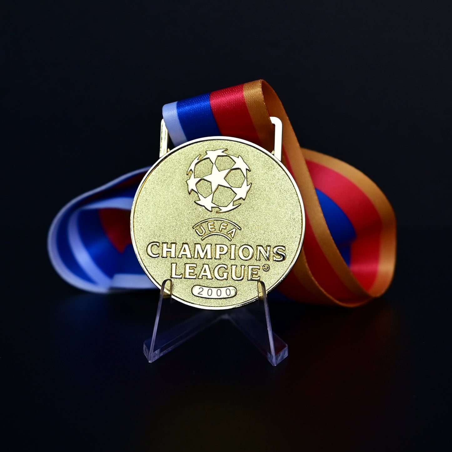 UEFA Champions League Medal Front View, Porto Champion Gold Alloy Medal with Official UCL Logo, 2000 Final Commemorative Medal on Clear Display Stand with Blue Tournament Ribbon