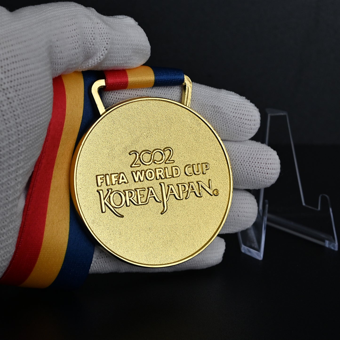 2002 FIFA World Cup Korea Japan Brazil Champions Medal - Front Close-Up Held in White Gloves, Highlighting Premium Alloy Finish & Official Design