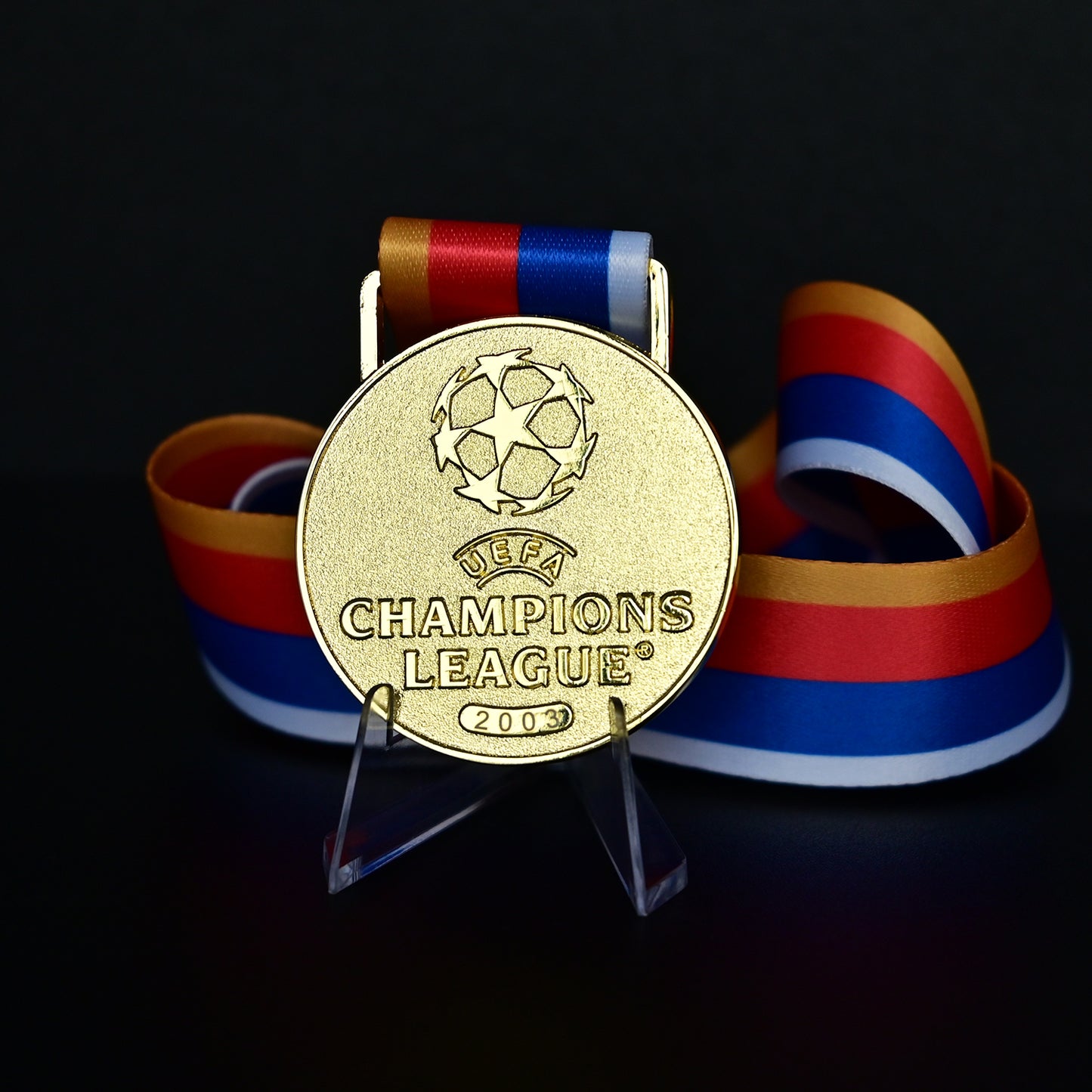 UEFA Champions League Medal Front View, Porto Champion Gold Alloy Medal with Official UCL Logo, 2003 Final Commemorative Medal on Clear Display Stand with Blue Tournament Ribbon