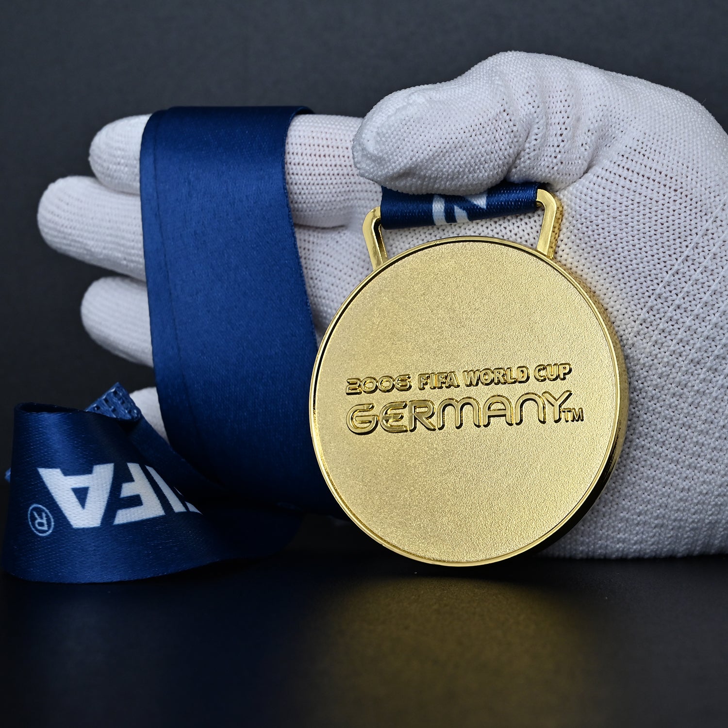 2006 FIFA World Cup Germany Italy Champions Medal - Front Close-Up Held in White Gloves, Highlighting Premium Alloy Finish & "2006 GERMANY" Text Engraving, Collectible Medal