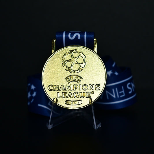 2007 UEFA Champions League Medal Front View, AC Milan Champion Gold Alloy Medal with Official UCL Logo, 2007 Final Commemorative Medal on Clear Display Stand with Blue Tournament Ribbon