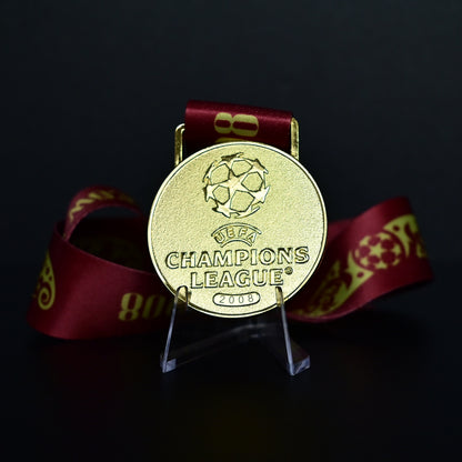 2008 UEFA Champions League Medal Front View, Manchester United Champion Gold Alloy Medal with Official UCL Logo, 2008 Final Commemorative Medal on Clear Display Stand with Blue Tournament Ribbon