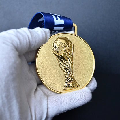 2010 FIFA World Cup South Africa Spain Champions Medal - Black Close-Up Held in White Gloves, Highlighting Premium Alloy Finish & Detailed 3D World Cup Trophy Embossment