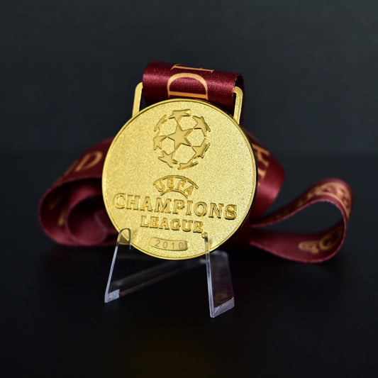 2010 UEFA Champions League Medal Front View, Inter Milan Champion Gold Alloy Medal with Official UCL Logo, 2010 Final Commemorative Medal on Clear Display Stand with Blue Tournament Ribbon