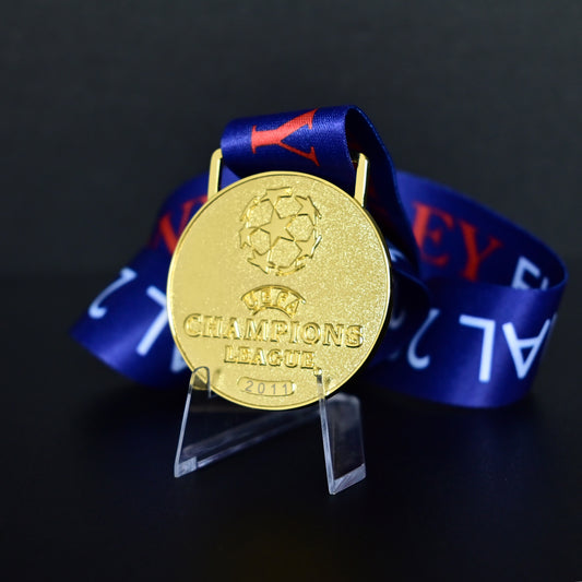 2011 UEFA Champions League Medal Front View, Barcelona Champion Gold Alloy Medal with Official UCL Logo, 2011 Final Commemorative Medal on Clear Display Stand with Blue Tournament Ribbon