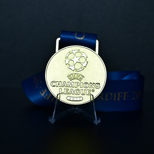 Medal with UEFA Champions League logo on a dark background