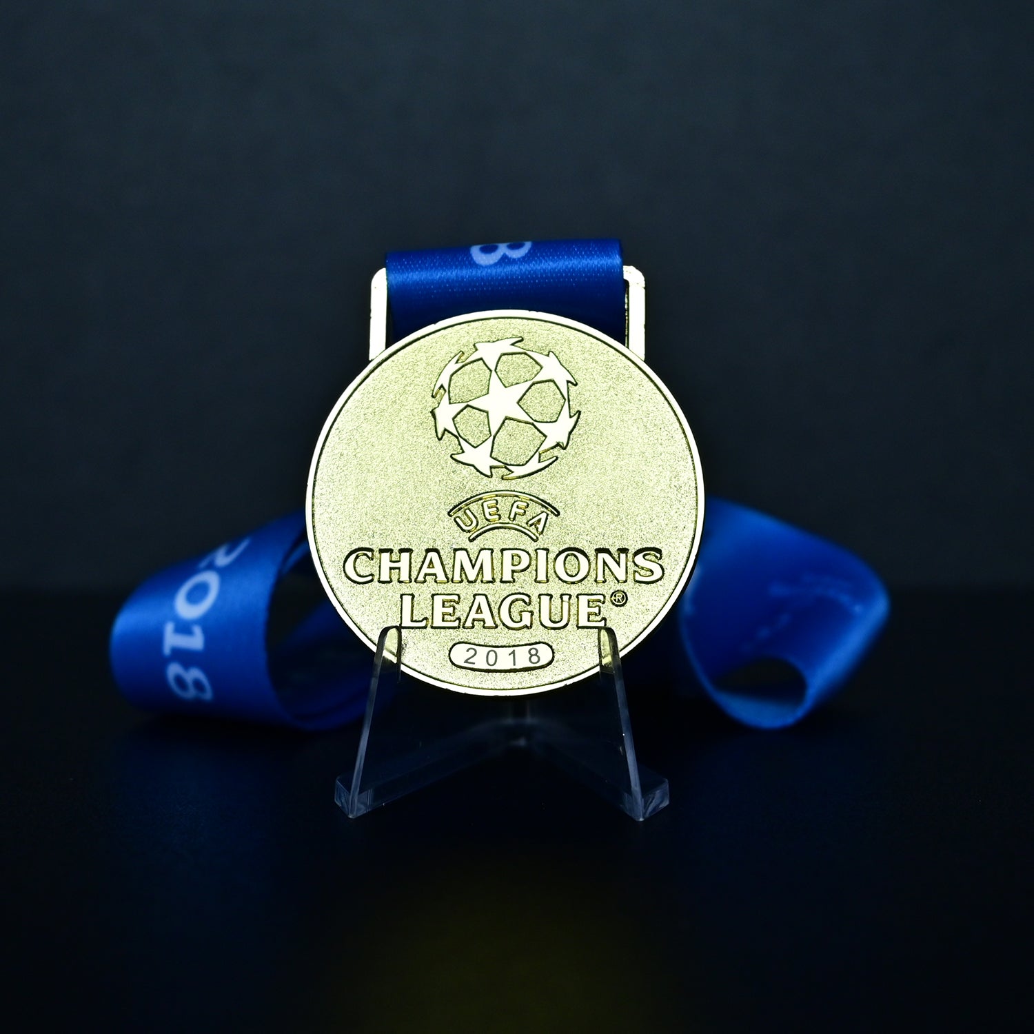 Medal with UEFA Champions League logo on a dark background