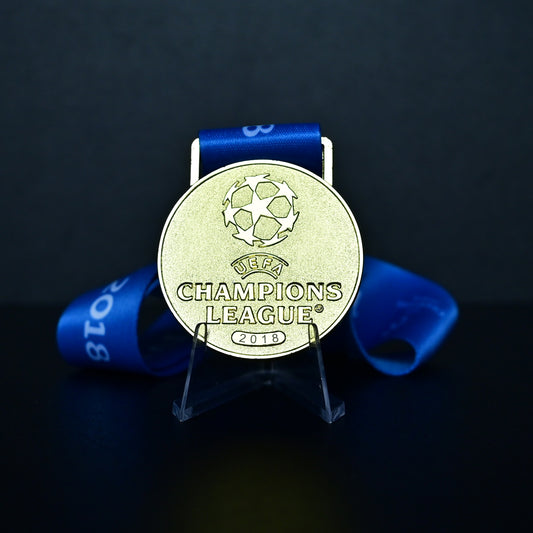 Medal with UEFA Champions League logo on a dark background