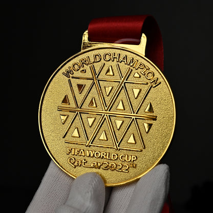 2022 FIFA World Cup Qatar Argentina Champions Medal - Back Close-Up Held in White Gloves, Intricate "WORLD CHAMPION" Text & Qatari Geometric Pattern Engraving, Premium Alloy Souvenir