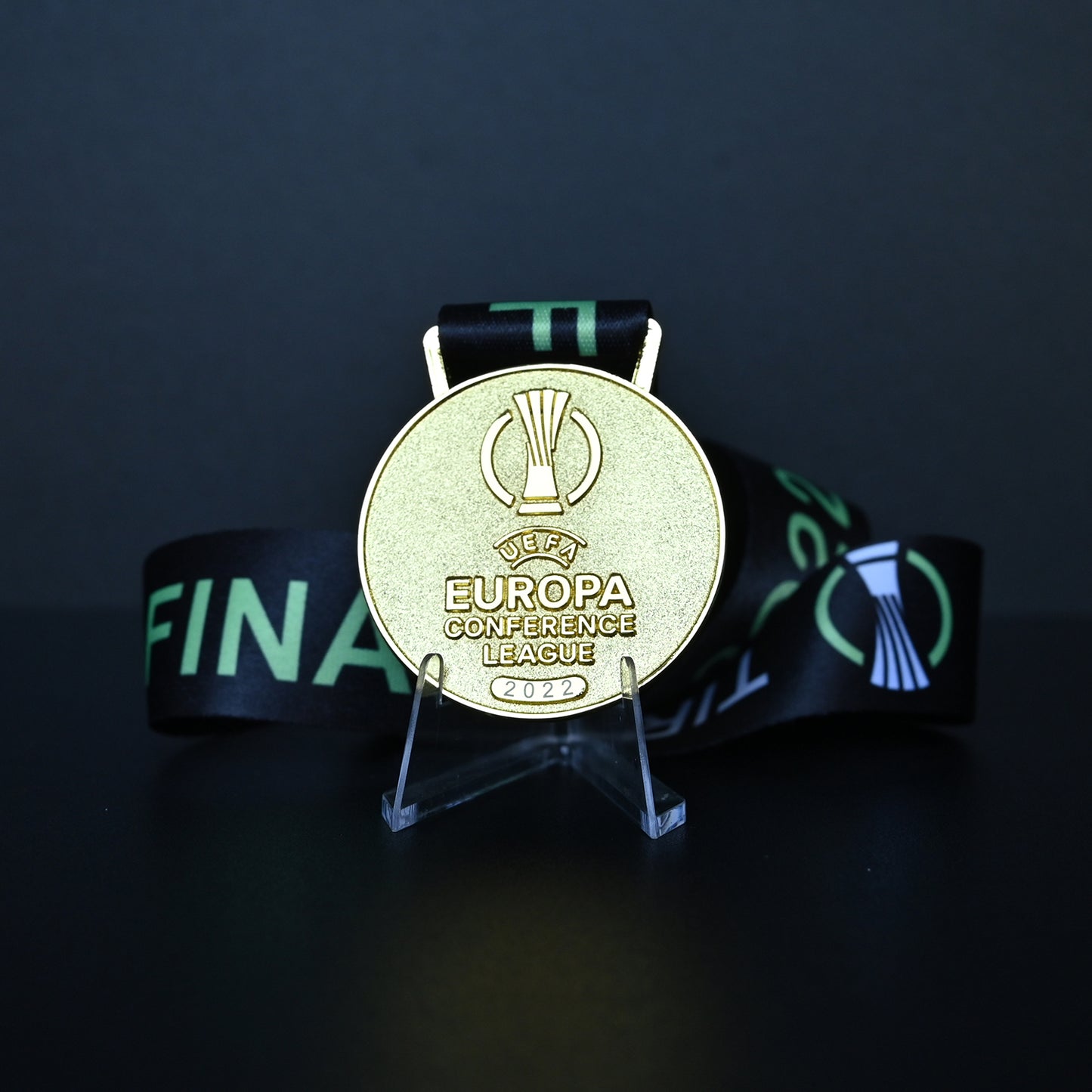 2022 UEFA Europa Conference League Medal Front View, Roma Champion Gold Alloy Medal with Official UECL Logo, Tirana Final Commemorative Medal on Clear Display Stand, Football Fan Collectible