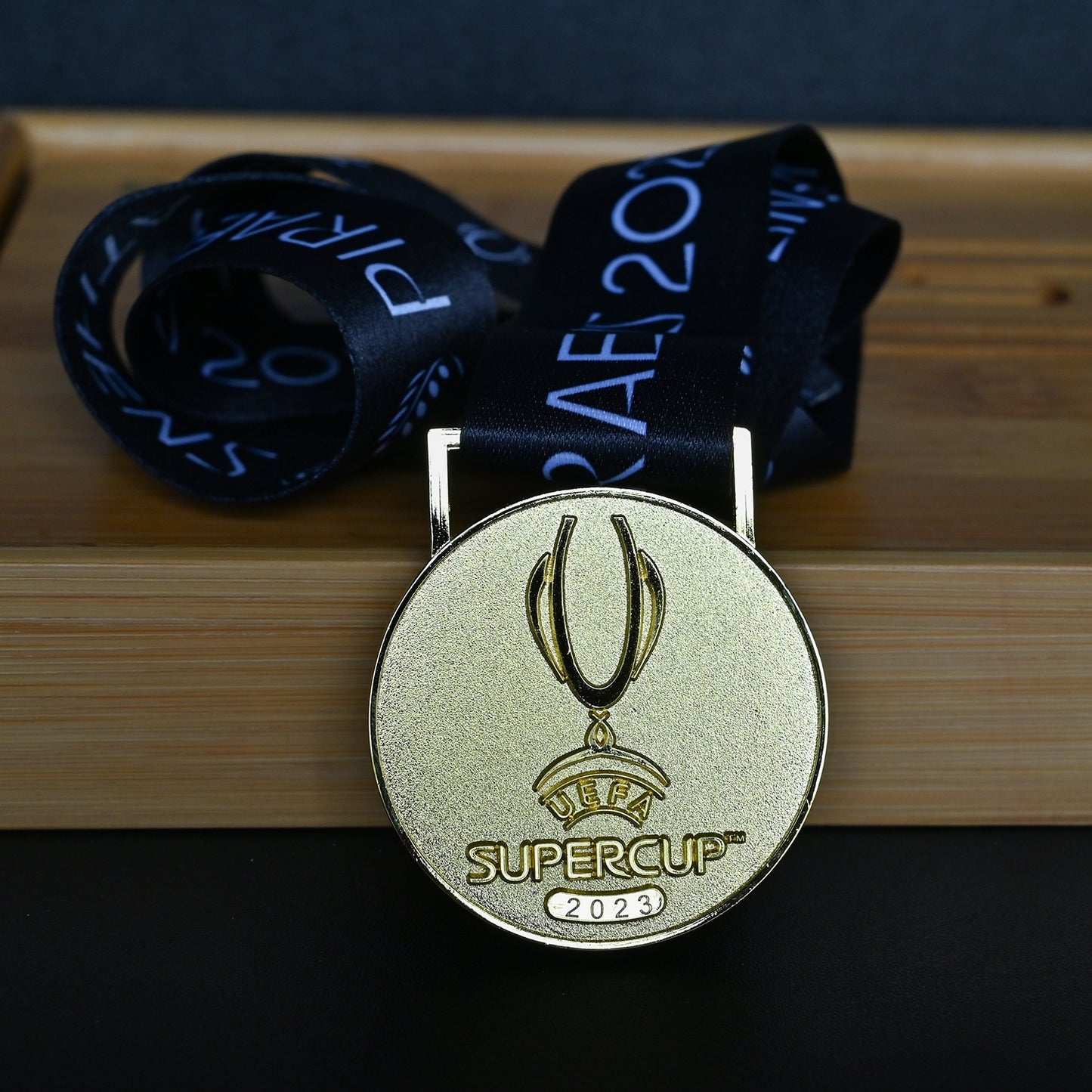 2023 UEFA Super Cup Medal Front View, Manchester City Champion Gold Alloy Medal with Official UEFA Logo, Athens Final Commemorative Medal on Clear Display Stand, Football Fan Collectible