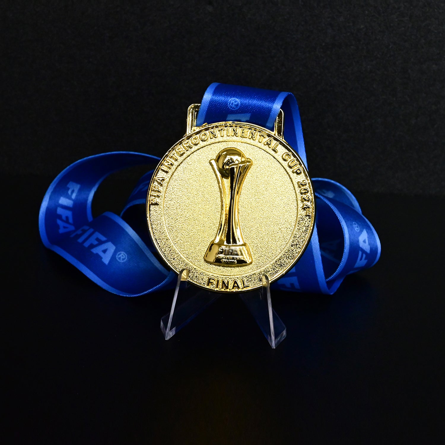 2024 FIFA Intercontinental Cup Medal Front View, Real Madrid Champion Gold Alloy Medal with Official FIFA Logo, Doha Final Commemorative Medal on Clear Display Stand, Football Fan Collectible