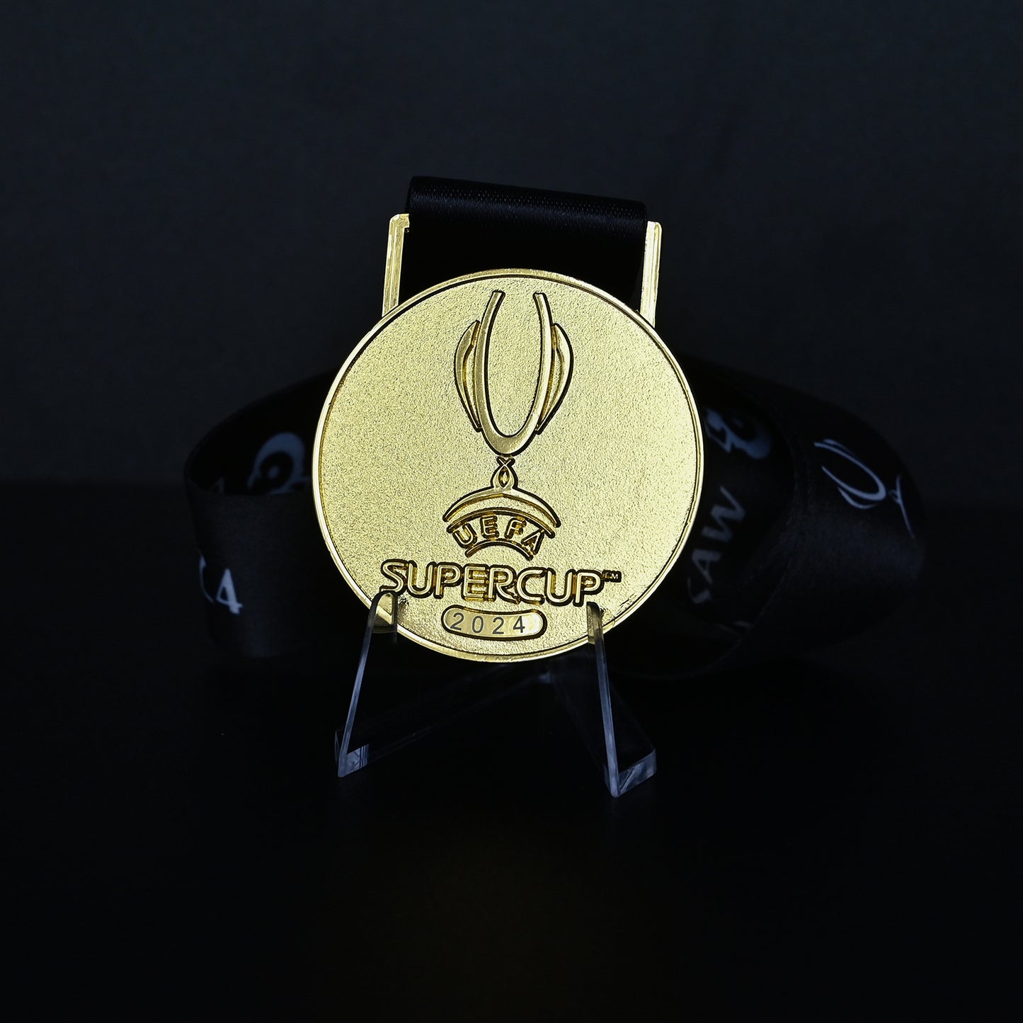 2024 UEFA Super Cup Medal Front View, Real Madrid Champion Gold Alloy Medal with Official UEFA Logo, Warsaw Final Commemorative Medal on Clear Display Stand, Football Fan Collectible