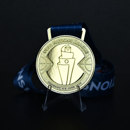 Medal with UEFA Nations League logo on a dark background