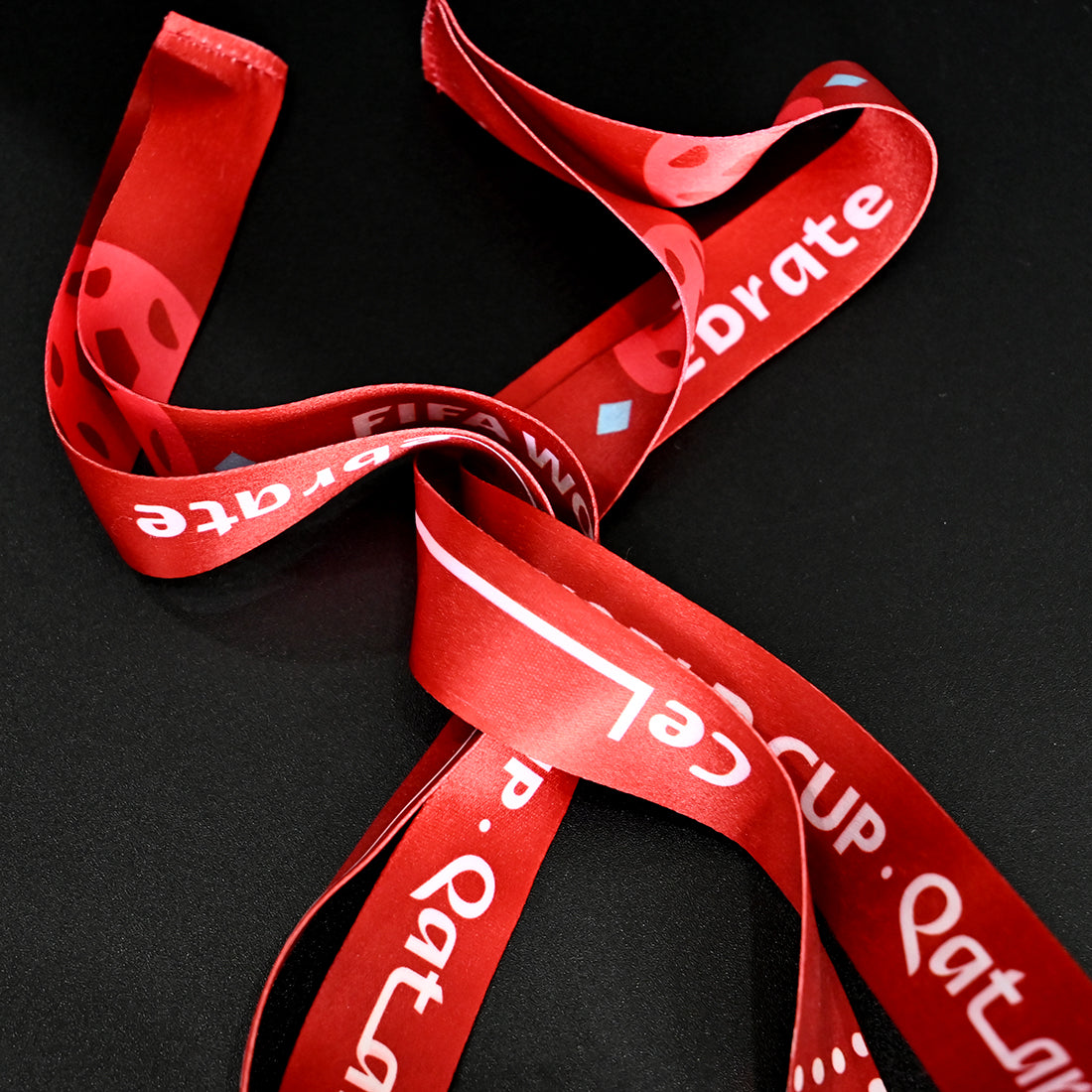 2022 FIFA World Cup Qatar Argentina Champions Medal - Red Commemorative Ribbon Close-Up, Featuring "FIFA WORLD CUP QATAR 2022" & "Celebrate" Text - Premium Souvenir Accessory for Football Fans