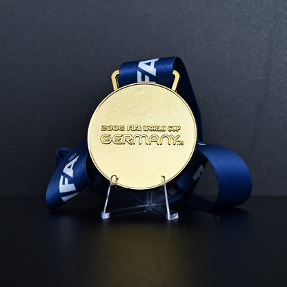 Germany 2006 FIFA World Cup Italy Champions Medal - Front View with Blue FIFA Ribbon, Featuring "2006 FIFA WORLD CUP GERMANY" Engraving, Premium Alloy Football Collectible