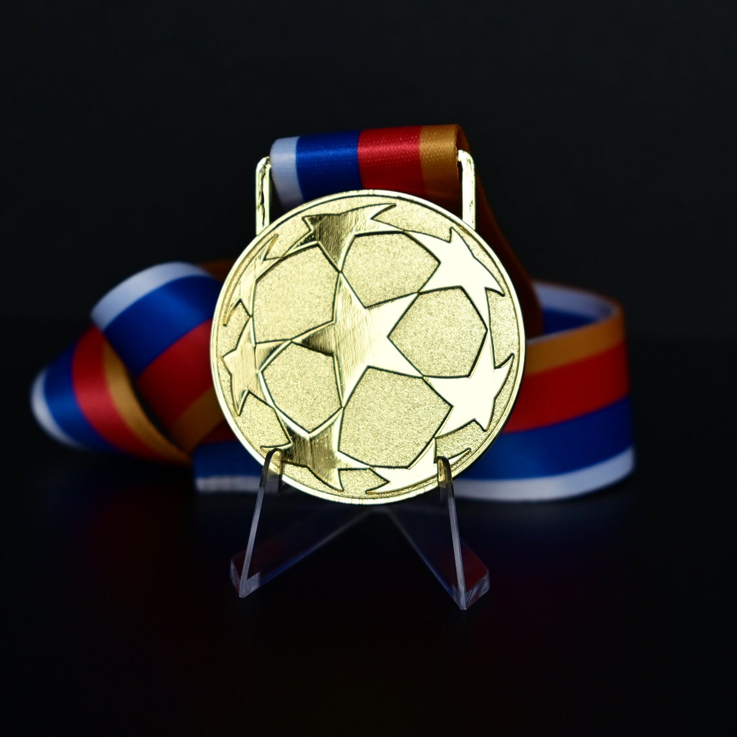 UEFA Champions League Medal Back View, Gold Alloy Medal with Starball Pattern, Commemorative Football Medal Close-up on Clear Stand