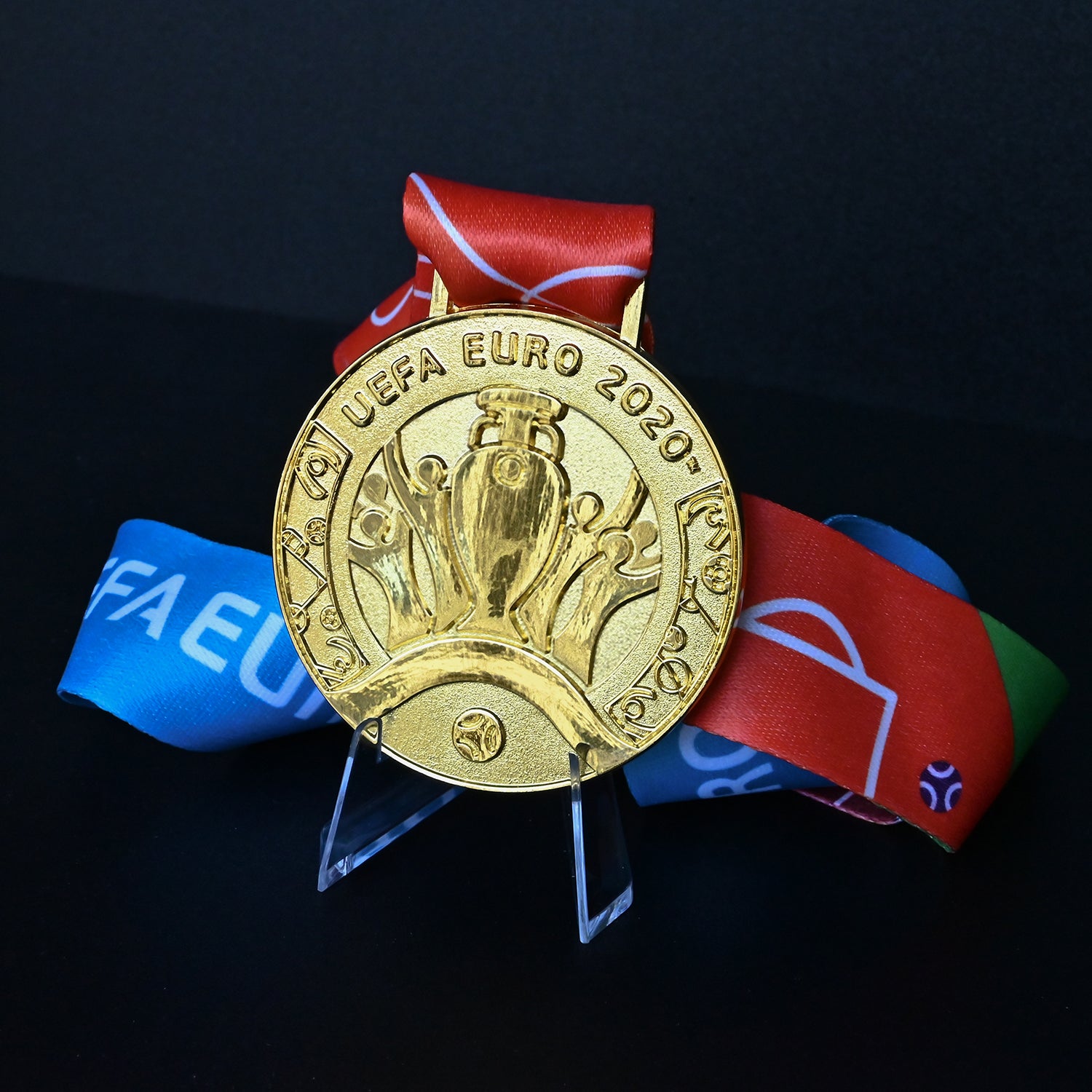 UEFA Euro 2020 medal featuring trophy-with-hands engraving, vibrant colorful ribbon. High-quality football memorabilia for Italy fans and collectors.